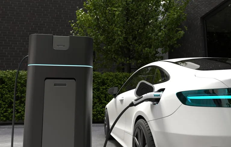 Electric vehicle charging beside renewable energy infrastructure